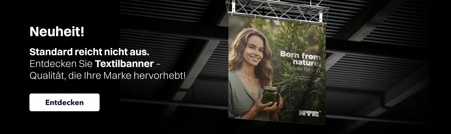 Website-Banner zur Bewerbung von Textilbannern mit dem Text „Neuheit! Entdecken Sie Textilbanner – Qualität, die Ihre Marke hervorhebt”